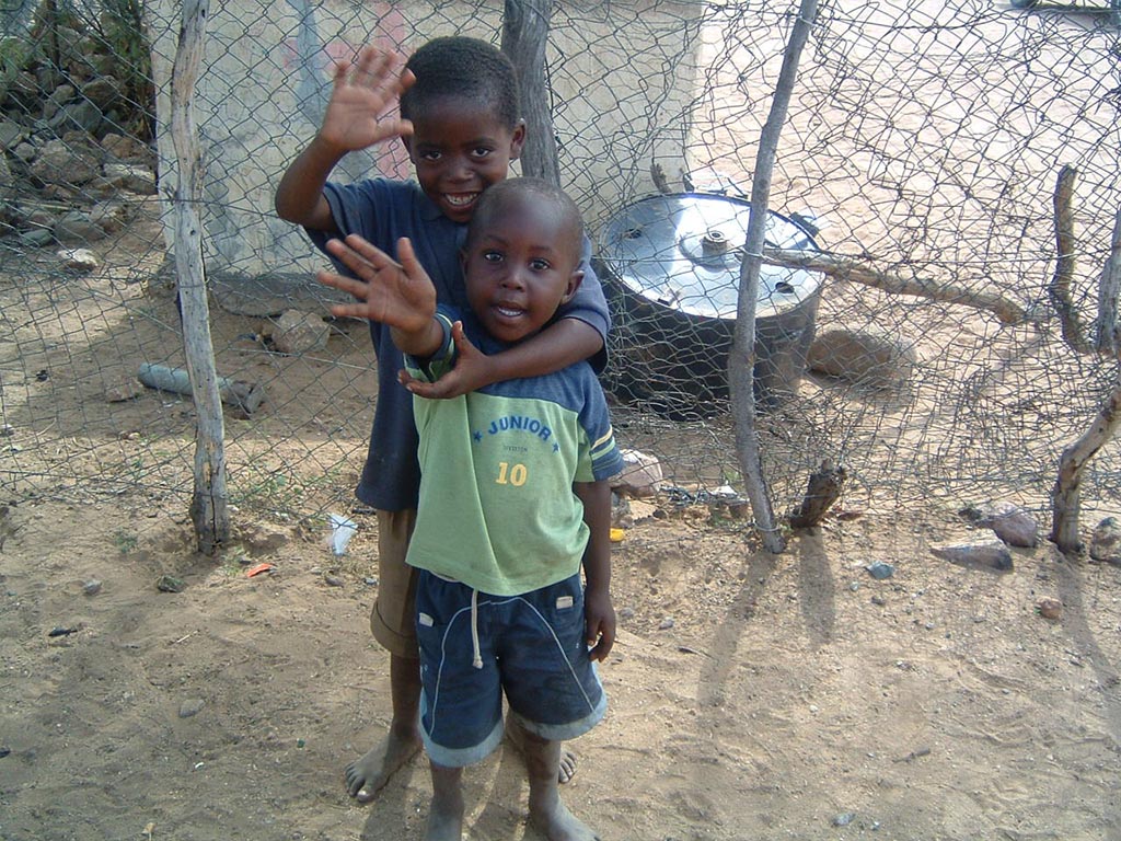Afrikanische Kinder winken in die Kamera